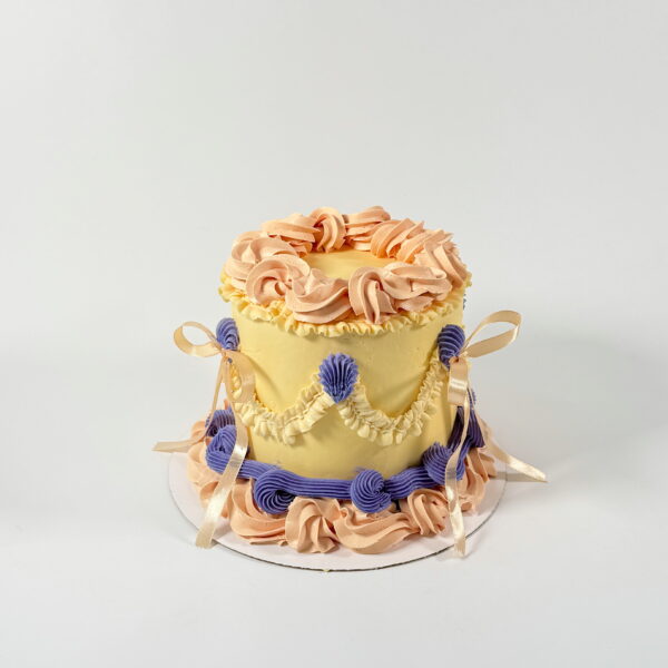 custom bow cake with scalloped pipping wholesome sweeter